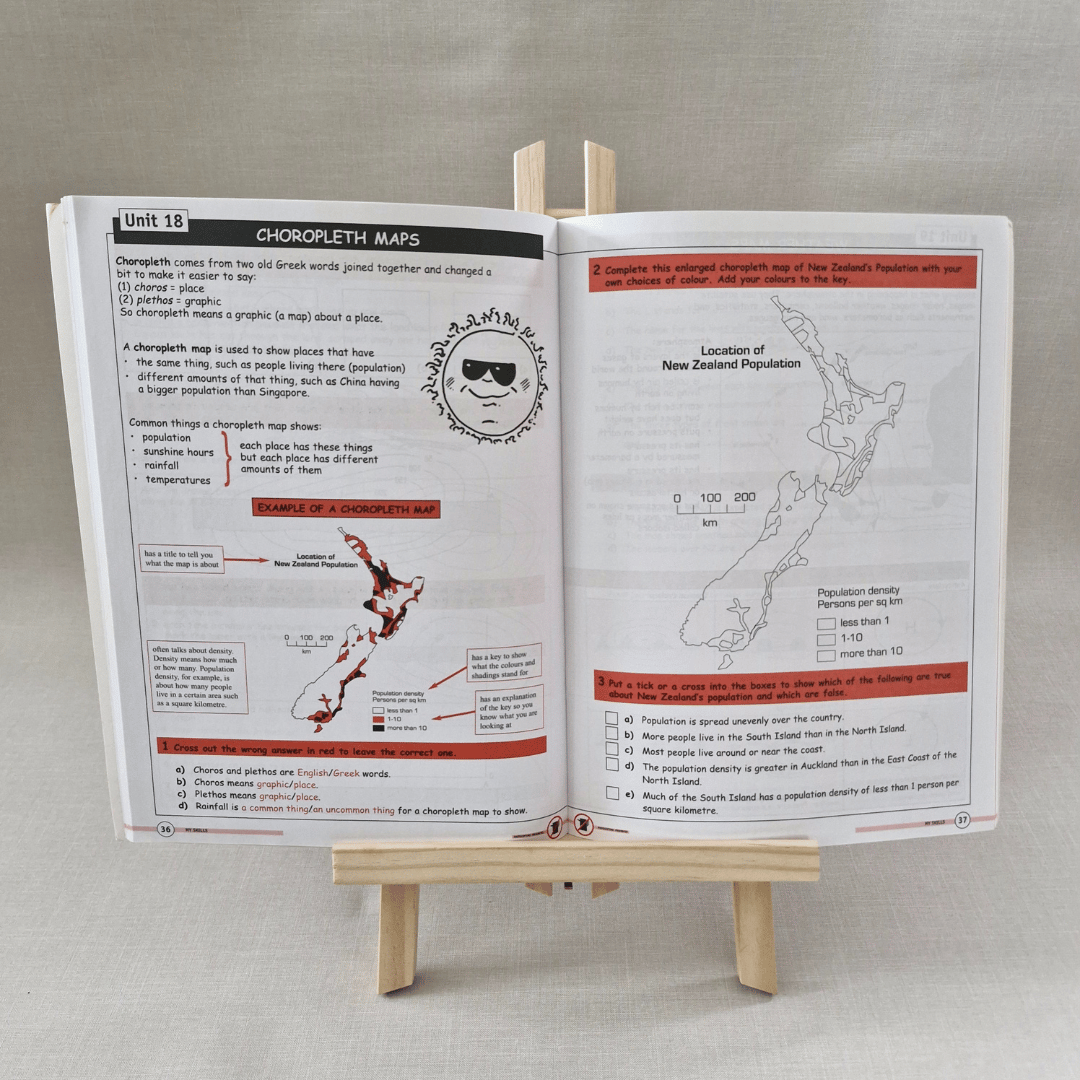 Open book on a stand with educational content on New Zealand maps