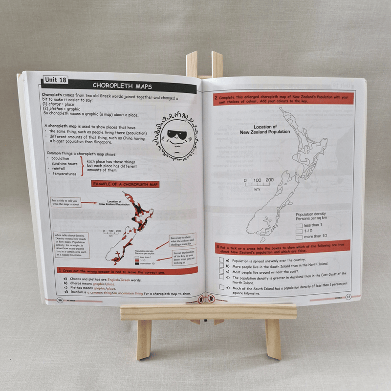 Open book on a stand with educational content on New Zealand maps