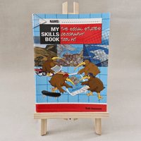 Book titled 'My Skills Book: The Social Studies Geography Tool Kit' on a wooden easel against a plain background