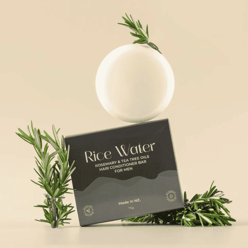 Rice Water hair conditioner bar with packaging and rosemary leaves on a beige background