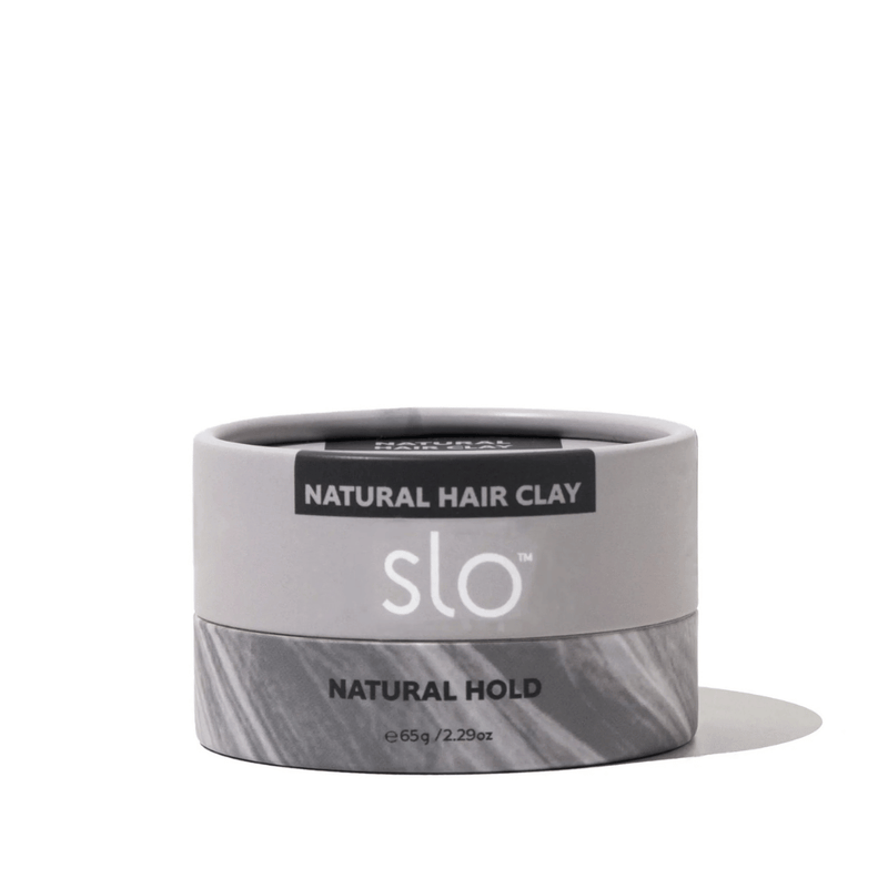 Jar of natural hair clay with 'slo' branding on a white background
