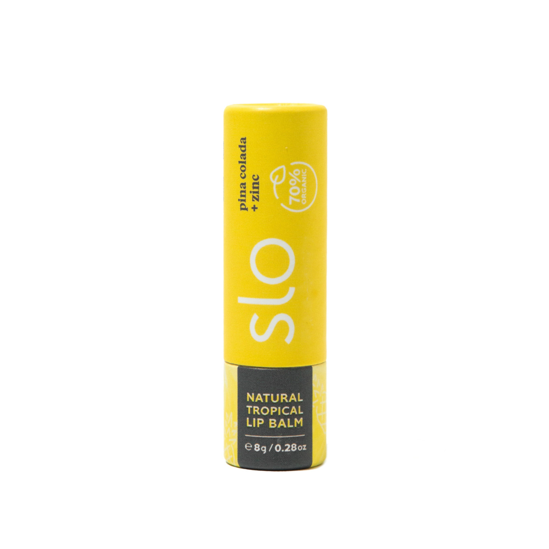 Yellow lip balm tube with 'slo' branding on a white background