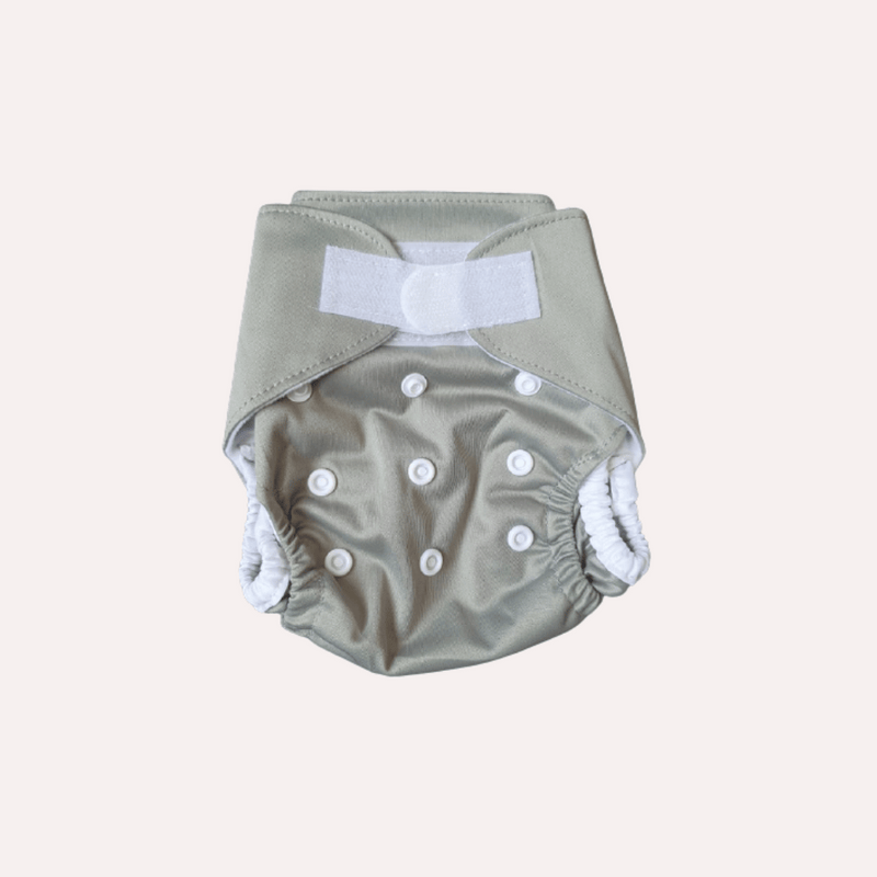 Grey newborn baby reusable cloth nappy with velcro on a white background