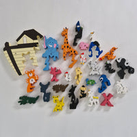 Collection of colourful animal-shaped  wooden alphabet shapes on a white background