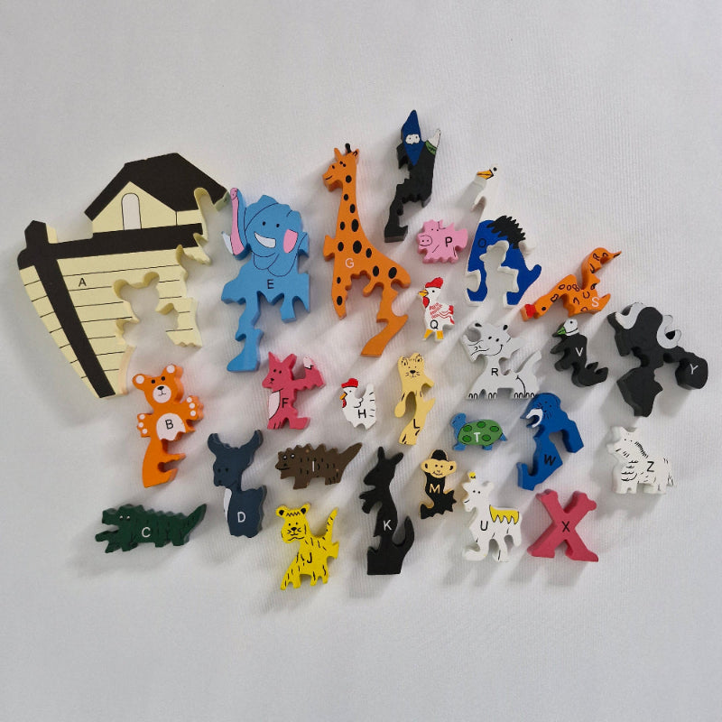 Collection of colourful animal-shaped  wooden alphabet shapes on a white background