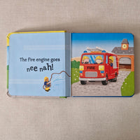 Children's book with a fire engine illustration on a textured surface