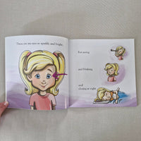 Open book with illustrations and text about a girl's eyes.
