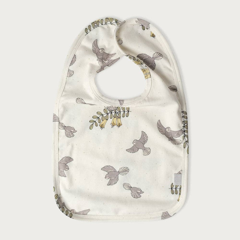 Baby bib with Piwakawaka Fantail bird pattern on a white background