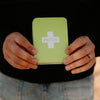 Person holding a green 'PATCH' case against a black background