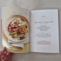 Open book showing a plate of food with a recipe underneath