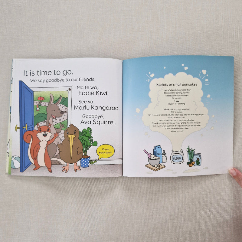 Open book showing end of story along with pikelet or small pancake recipe, illustrations of animals and text on a neutral background