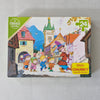 Jigsaw puzzle box with colorful illustration on a grey surface