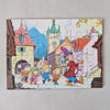 Colorful puzzle with cartoon characters and buildings on a grey background