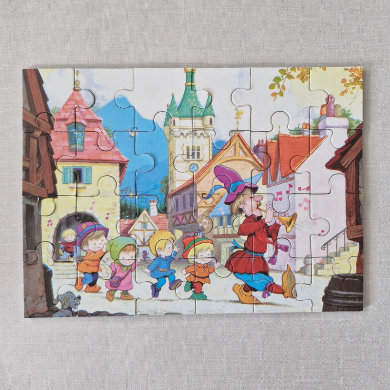 Colorful puzzle with cartoon characters and buildings on a grey background