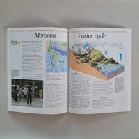 Open book on a flat surface with illustrations and text about the water cycle and Monsoon.