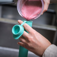 Pouring smoothie into a blue silicone reusable ice block mould