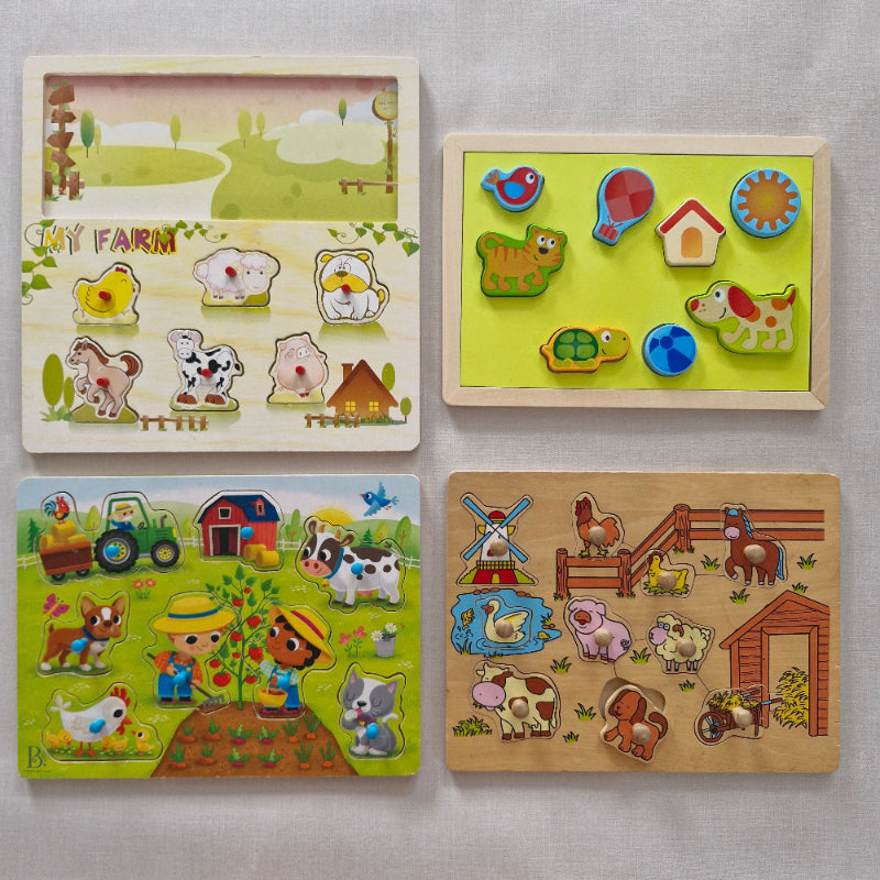 Four wooden puzzles with colourful illustrations of animals and scenes on a light gray background.