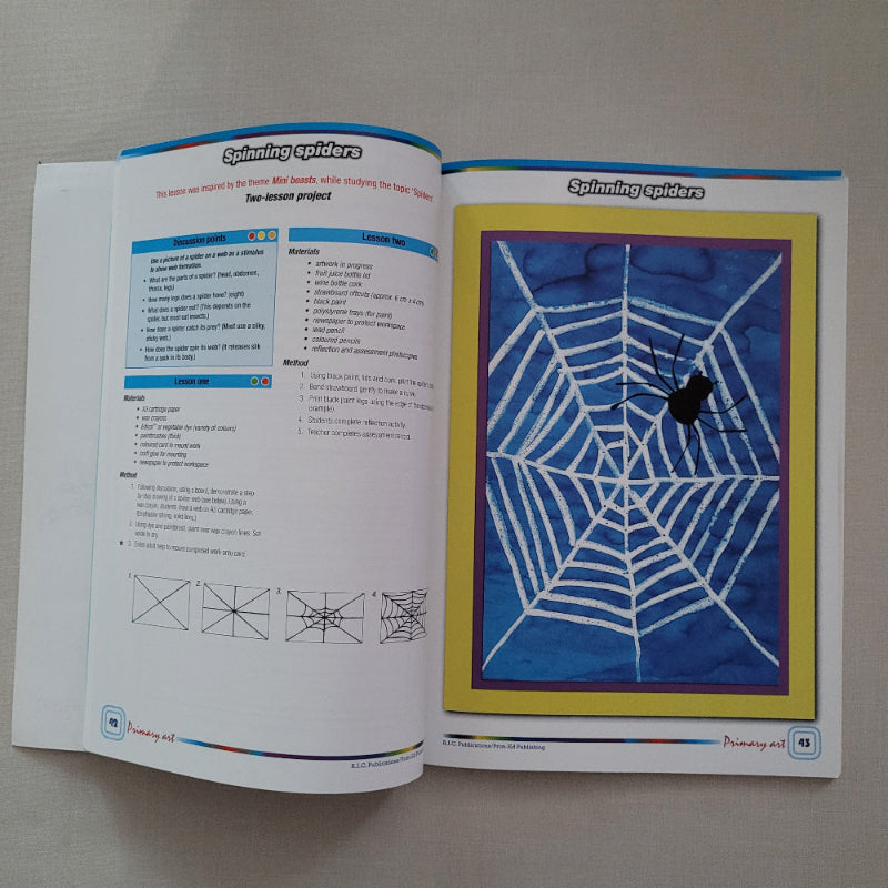 Open book with a spider web illustration on a gray background