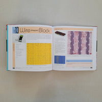 Open book with text and images of wire block printing on a plain background