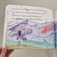 Illustrated page from a book with a purple character and red object on a beige background