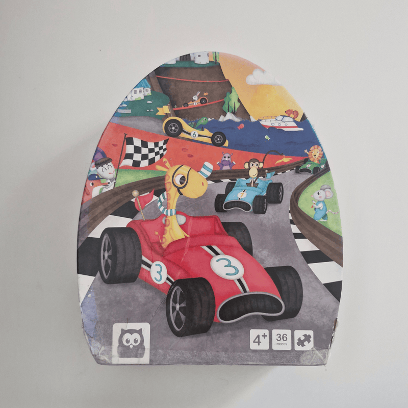 Children's puzzle packaging with cartoon race cars and characters on a gray background