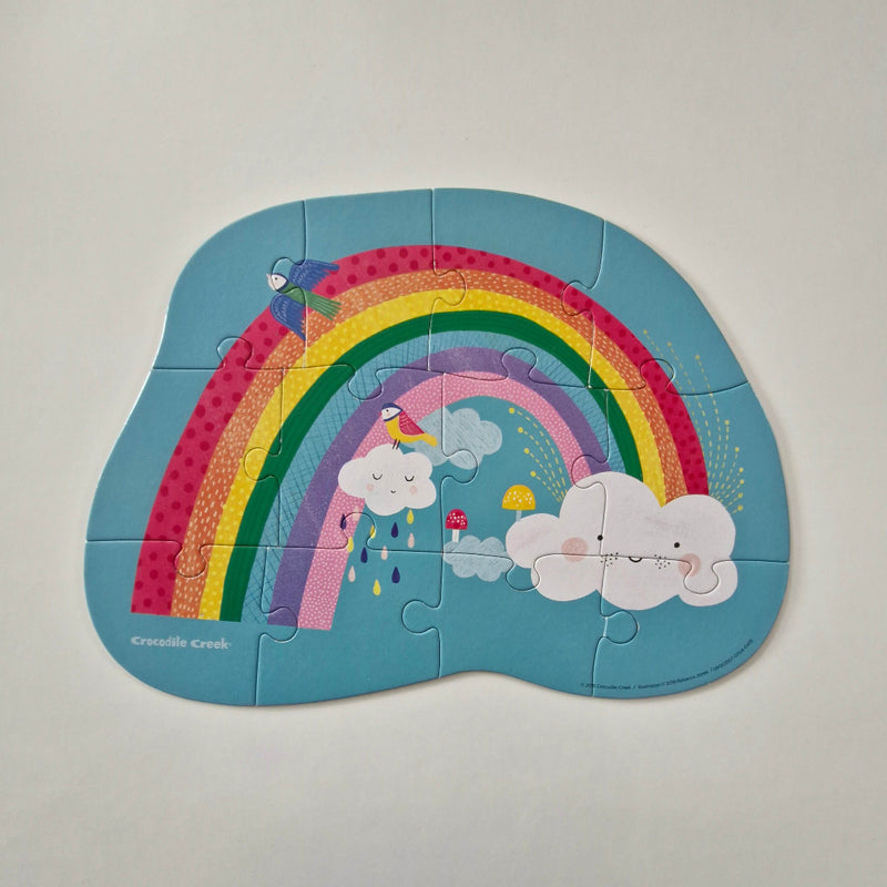 Children's puzzle with a rainbow and cloud design on a light gray background