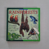 Book titled 'Rainforests' with illustrations of animals on a green background