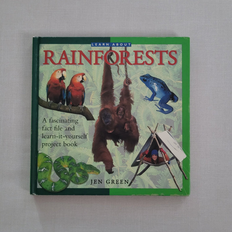 Book titled 'Rainforests' with illustrations of animals on a green background
