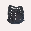 Black reusable cloth nappy with white buttons on a light grey background