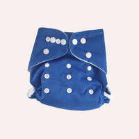 Blue cloth reusable nappy with white buttons on a light grey background