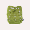 Green cloth reusable nappy with white buttons on a light grey background