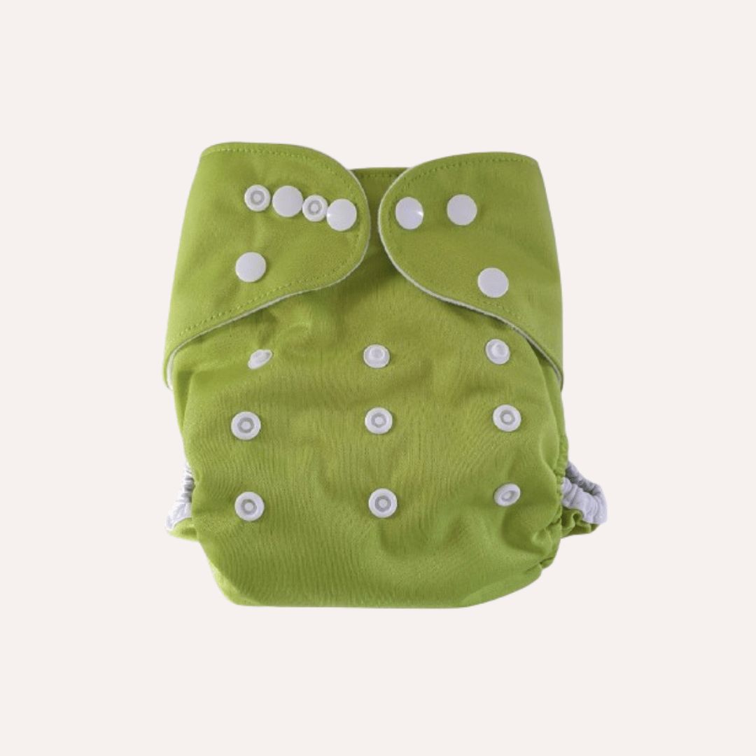 Green cloth reusable nappy with white buttons on a light grey background