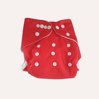 Red reusable cloth nappy with white buttons on a light grey background