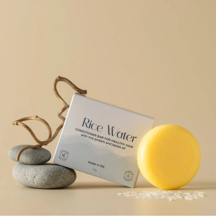Solid conditioner bar and 'Rice Water' packaging on a beige background