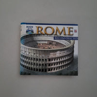 Book titled 'Rome Reconstructed' with a Colosseum image on the cover, placed on a gray surface.
