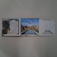 Book with images of a architectural site on a gray background