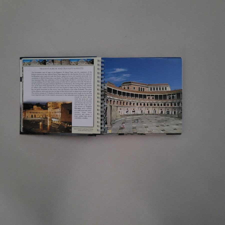 Spiral-bound book with architectural images on a gray background