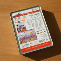 Educational kit packaging for 'Discover Oceans' on a wooden surface