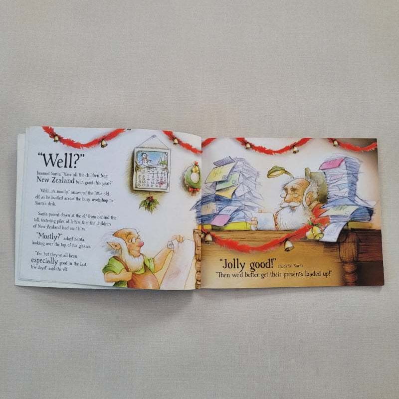 An open children's picture book spread on a light beige fabric background. The left page shows a holiday-themed illustration with text starting 'Well?' and a small calendar graphic.