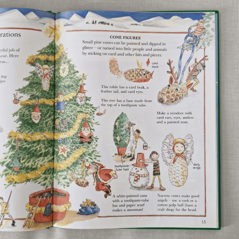Open book with Christmas-themed illustrations and text on a textured surface