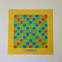 Scrabble board game board with letter tiles on a yellow background