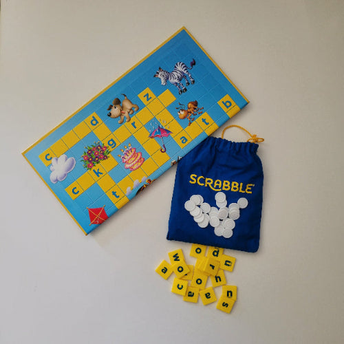 Scrabble game set with tiles and bag on a light background