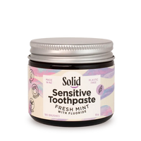 Jar of Solid Sensitive Toothpaste with a colourful label on a white background
