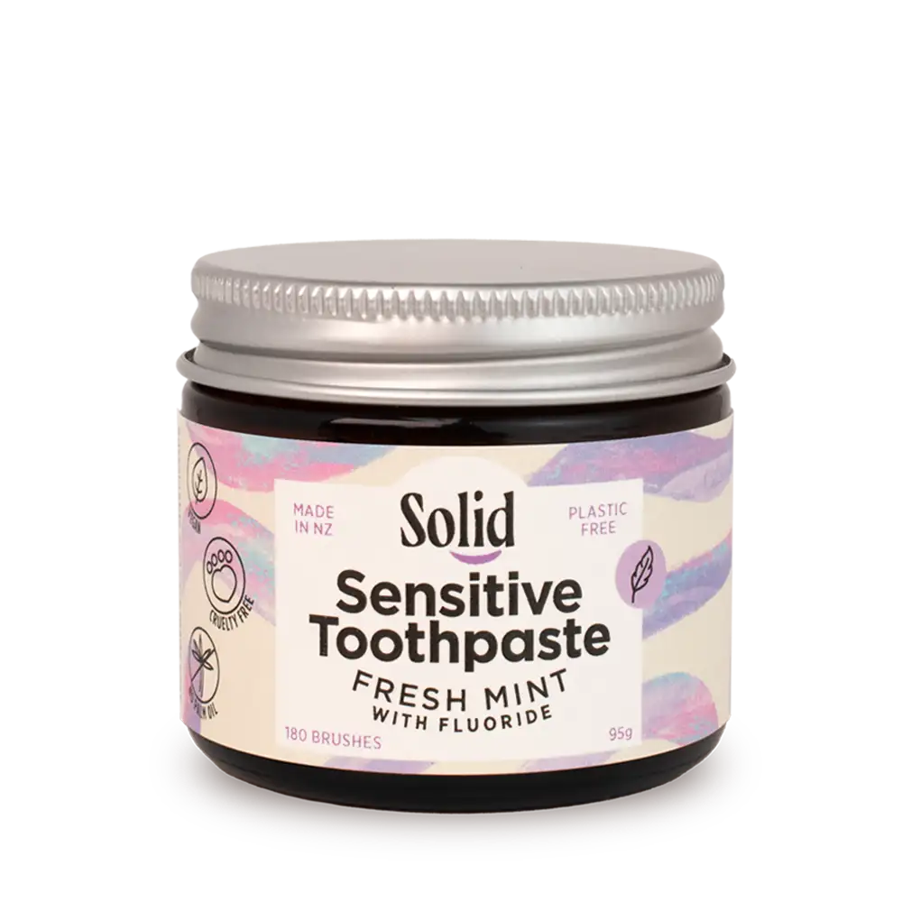 Jar of Solid Sensitive Toothpaste with a colourful label on a white background