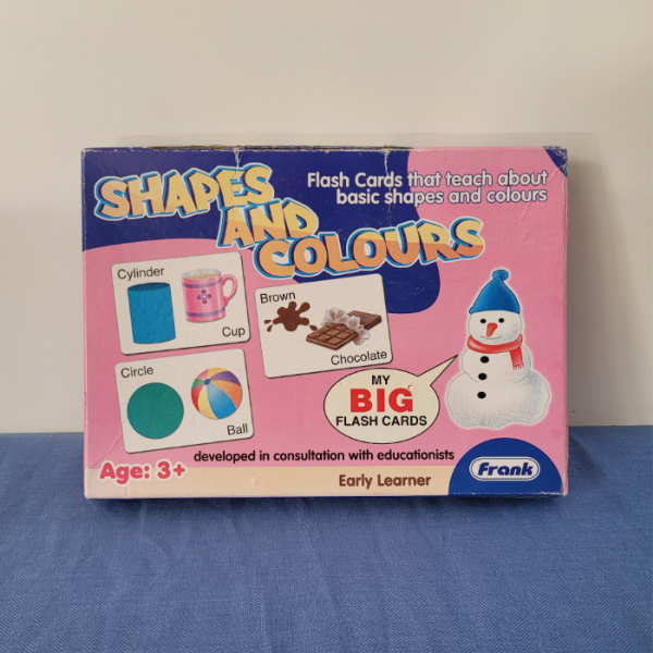 A box of 'Shapes and Colours Big Flash Cards' by Frank, designed to teach basic shapes and colours to young children, with illustrations of a snowman, a pizza slice, and a cup on the cover.