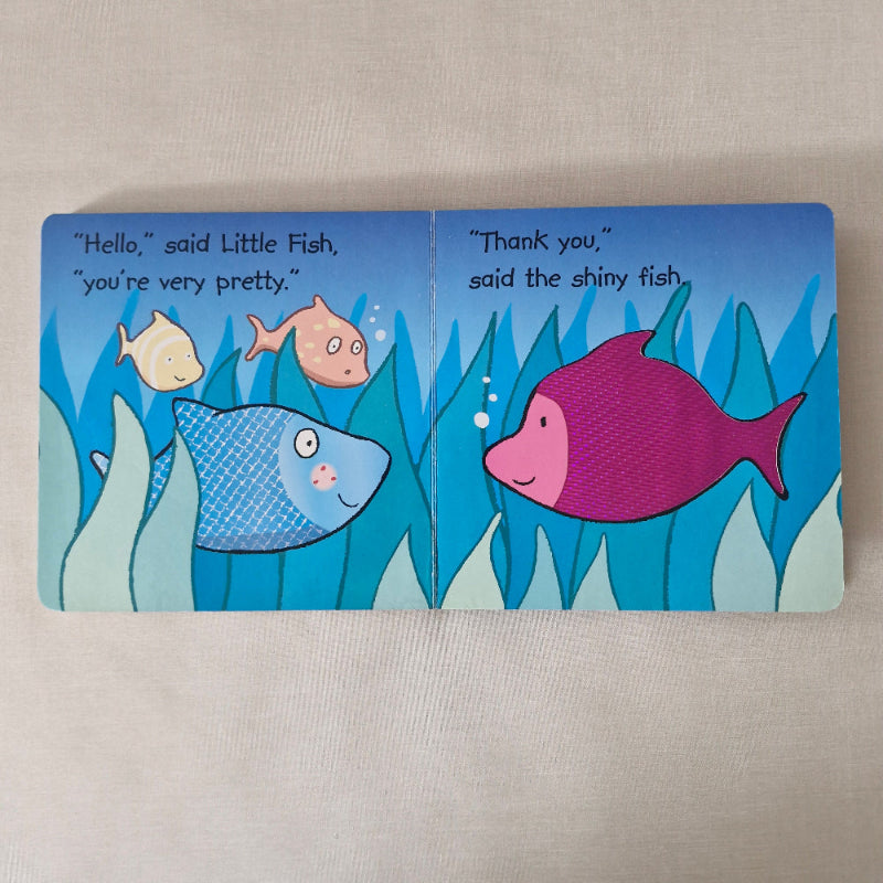 Children's book with fish illustrations on a beige background