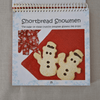 Cookbook with shortbread snowmen on a red background