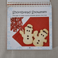 Cookbook with shortbread snowmen on a red background