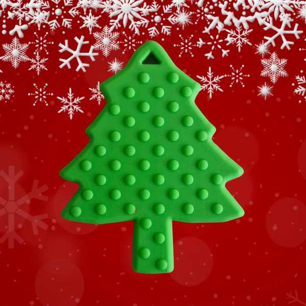 Christmas tree shaped teether for babies on a red background