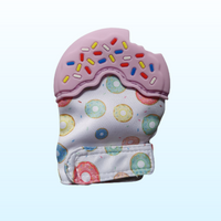 Silicone purple teething mitt in the shape of a donut with sprinkles